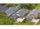 Aerial view of a luxury home with tile roof, well-manicured landscaping and a stone paved driveway at 10214 Chiltern Garden Dr, Orlando, FL 32827