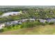Stunning aerial view of the community showcasing the beautiful homes, lush greenery, and a serene lake at 10214 Chiltern Garden Dr, Orlando, FL 32827