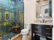 Spa-like bathroom with a mosaic shower and modern vanity at 10214 Chiltern Garden Dr, Orlando, FL 32827