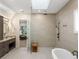 Spa-like bathroom with walk-in shower and soaking tub at 10214 Chiltern Garden Dr, Orlando, FL 32827