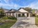 Modern single-story home with stone accents and a paver driveway at 10214 Chiltern Garden Dr, Orlando, FL 32827