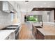 Elegant kitchen showcasing custom backsplash, hardwood flooring, professional-grade appliances, and an open layout at 10214 Chiltern Garden Dr, Orlando, FL 32827