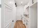 Clean laundry room with white cabinets, modern appliances, and ample counter space for easy folding and organization at 10214 Chiltern Garden Dr, Orlando, FL 32827