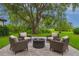 Cozy outdoor living space features a fire pit with comfortable seating surrounded by a lush green landscape at 10214 Chiltern Garden Dr, Orlando, FL 32827