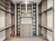 Spacious walk-in closet with custom shelving, drawers, and ample hanging space, perfect for organization and storage at 10214 Chiltern Garden Dr, Orlando, FL 32827