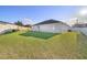 Lush green back yard and white fencing at 1858 Snapper Dr, Kissimmee, FL 34759