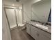 Bathroom featuring granite vanity and shower at 2334 Zaballina Pl, Kissimmee, FL 34747