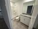 Bathroom with granite countertop, white cabinets and a bathtub at 2334 Zaballina Pl, Kissimmee, FL 34747