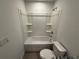 Clean bathroom with a bathtub, toilet and shelves at 2334 Zaballina Pl, Kissimmee, FL 34747