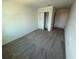 Bright bedroom featuring grey carpet and closet at 2334 Zaballina Pl, Kissimmee, FL 34747