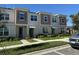 Two-story townhome with neutral siding and landscaping at 2334 Zaballina Pl, Kissimmee, FL 34747