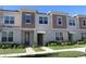 Two story townhome with neutral siding and landscaping at 2334 Zaballina Pl, Kissimmee, FL 34747