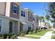 Row of two-story townhomes with neutral siding at 2334 Zaballina Pl, Kissimmee, FL 34747