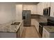 Modern kitchen with white cabinets, granite countertops, and stainless steel appliances at 2334 Zaballina Pl, Kissimmee, FL 34747