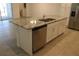 Kitchen island with granite countertop and double sink at 2334 Zaballina Pl, Kissimmee, FL 34747