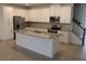 Modern kitchen with white cabinets, granite countertops, and stainless steel appliances at 2334 Zaballina Pl, Kissimmee, FL 34747