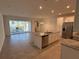 Open kitchen features granite island, stainless steel appliances, and view of pool at 2334 Zaballina Pl, Kissimmee, FL 34747