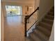 Modern staircase with dark wood handrail and carpeted steps at 2334 Zaballina Pl, Kissimmee, FL 34747