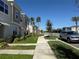 Townhome community street view, sidewalks, landscaping at 2334 Zaballina Pl, Kissimmee, FL 34747