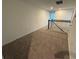 Upstairs hallway with a carpeted floor and railing at 2334 Zaballina Pl, Kissimmee, FL 34747