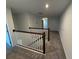 Upstairs hallway with dark wood railings and carpet at 2334 Zaballina Pl, Kissimmee, FL 34747