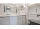 Bathroom features a white vanity, large mirrors, and a combined shower and tub at 314 Cherokee Ct # H, Altamonte Springs, FL 32701