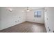 Bright bedroom with updated flooring, natural light from window, and decorative lighting fixtures on the walls at 314 Cherokee Ct # H, Altamonte Springs, FL 32701