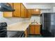 Efficient kitchen with wood cabinets, light countertops, and modern appliances for convenient cooking at 314 Cherokee Ct # H, Altamonte Springs, FL 32701
