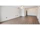 Bright living room with wood-look floors flowing into tiled dining area, adjacent to a door and closet at 314 Cherokee Ct # H, Altamonte Springs, FL 32701