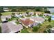 Aerial view of neighborhood homes, lake, and community features at 4731 Summerbridge Cir, Leesburg, FL 34748