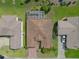 An aerial view showcasing the home's layout, screened-in patio, and proximity to neighboring houses at 4731 Summerbridge Cir, Leesburg, FL 34748