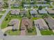 An aerial view of a beautiful home surrounded by well-maintained landscaping and a lush green lawn at 4731 Summerbridge Cir, Leesburg, FL 34748