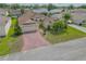Single-story home with mature landscaping and brick driveway in a residential neighborhood at 4731 Summerbridge Cir, Leesburg, FL 34748