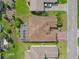 An aerial view displays the home's well-kept backyard, screened enclosure, and convenient two-car garage at 4731 Summerbridge Cir, Leesburg, FL 34748