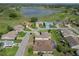 An aerial view of homes within a lush community near a golf course and a scenic body of water at 4731 Summerbridge Cir, Leesburg, FL 34748