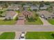 Single-story home with mature landscaping and brick driveway in a residential neighborhood at 4731 Summerbridge Cir, Leesburg, FL 34748
