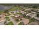 Aerial view showcasing the neighborhood, lake, and nearby golf course at 4731 Summerbridge Cir, Leesburg, FL 34748