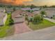 Charming single-story home with a well-manicured lawn, brick driveway, and two-car garage at 4731 Summerbridge Cir, Leesburg, FL 34748