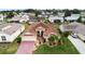A beautiful single-Gathering home featuring a well-manicured lawn, a brick driveway, and a two-car garage at 4731 Summerbridge Cir, Leesburg, FL 34748