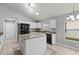 Well-lit kitchen features granite countertops, white cabinetry, and stainless steel appliances at 4731 Summerbridge Cir, Leesburg, FL 34748