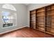 Cozy office space with wood floors, built-in bookshelves, and a bright window at 4731 Summerbridge Cir, Leesburg, FL 34748