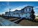 New townhome community featuring modern two-story homes with landscaping at 592 Pothos St, Apopka, FL 32703