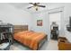 This bedroom features warm paint, a modern light fixture, and a neutral design at 6115 Claystone Way, Mount Dora, FL 32757