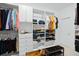 Walk-in closet with custom shelving, ample hanging space, and a bench for added convenience at 6115 Claystone Way, Mount Dora, FL 32757