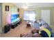 Bright living room featuring a large TV and comfortable seating at 704 Monroe Harbor Pl, Sanford, FL 32773
