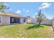 Backyard view of house with screened porch at 9355 Westmorely St, Groveland, FL 34736