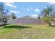 Backyard with grassy area and privacy fence at 9355 Westmorely St, Groveland, FL 34736