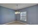 Bright dining area with a chandelier and plantation shutters at 9355 Westmorely St, Groveland, FL 34736