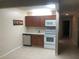 Efficient kitchen features white appliances and ample wood cabinetry at 134 W America St # 29, Orlando, FL 32801