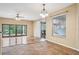 Bright dining room with hardwood floors, sliding glass doors, and a view of the backyard at 13632 Paytons Way, Orlando, FL 32828